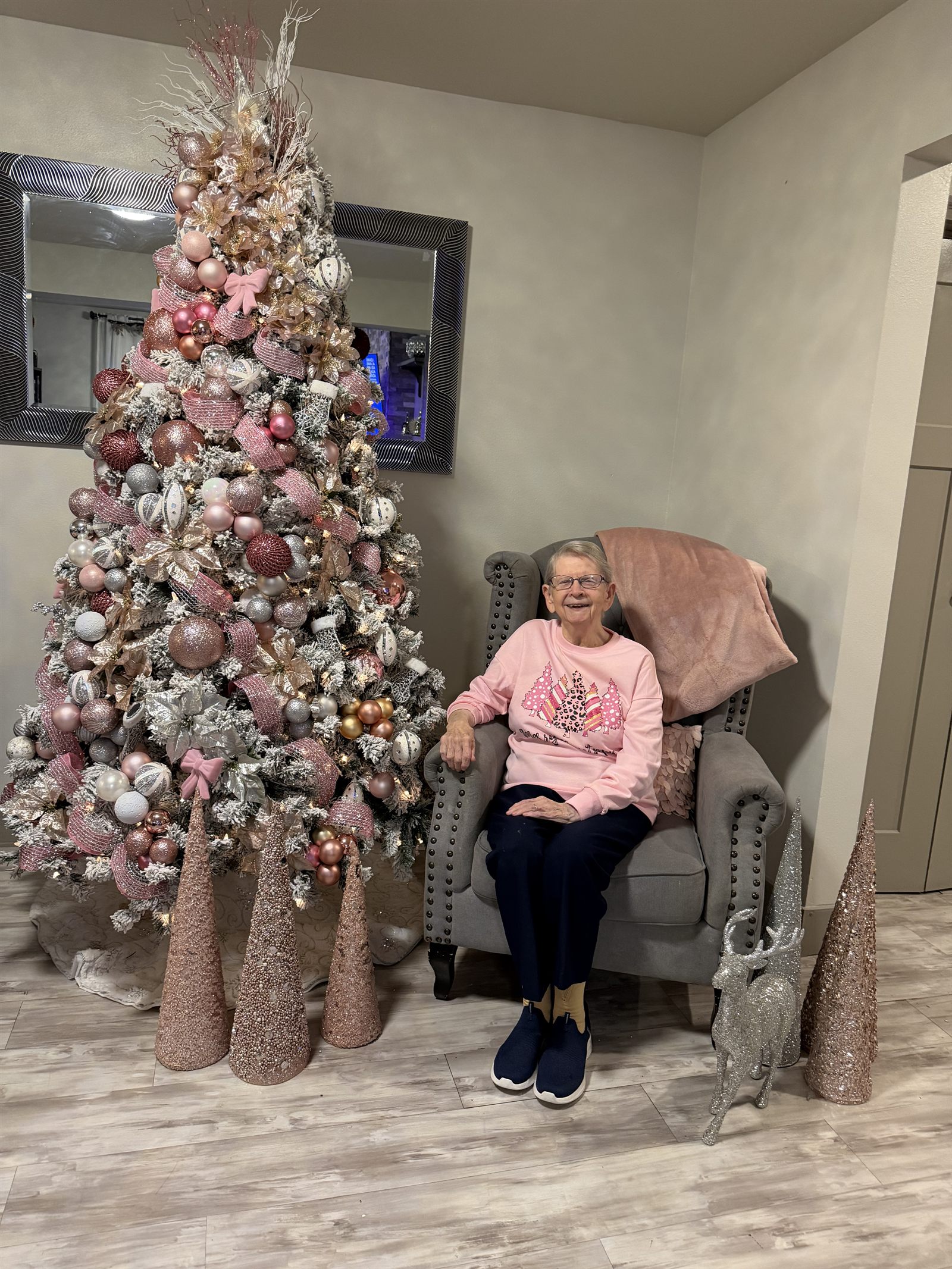 A resident beside the tree in a festive jumper